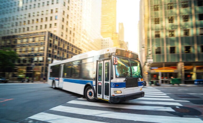 A bus making a wide turn on city streets